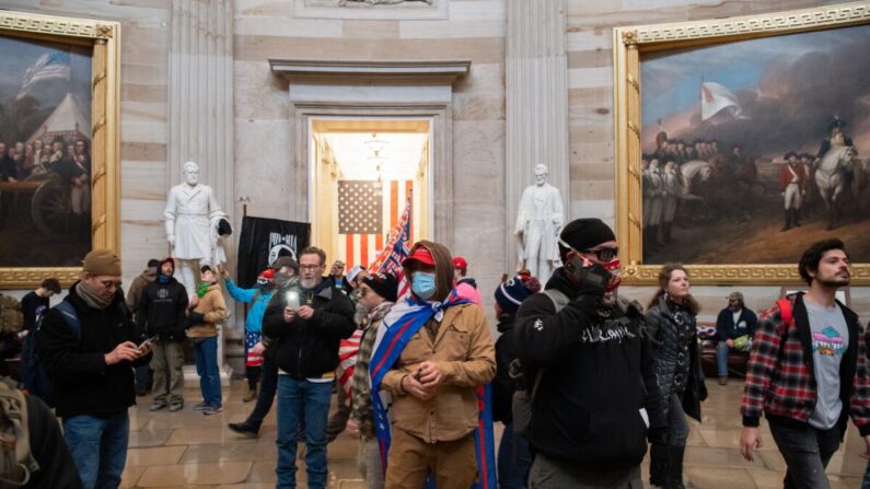 Manifestantes caminan en la Rotonda después de irrumpir en el Capitolio de Estados Unidos, en Washington, el 6 de enero de 2021. (Saul Loeb/AFP vía Getty Images)