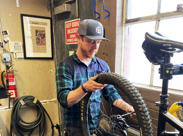Chuck Seppanen, mecánico jefe de Flagstaff Bicycle Revolution en Arizona, trabaja en la reparación de la bicicleta de un cliente el 12 de octubre. A pesar de la escasez de piezas en muchas tiendas de bicicletas, el montaje y las reparaciones siguen siendo rápidos. (Allan Stein/The Epoch Times)