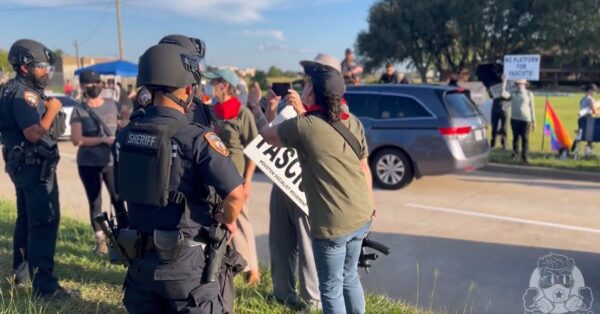 Screenshot from video recorded on September 24, 2022 by undercover, independent journalist Tayler Hansen showing an armed liberal supporter of the new Transparent Closet at the First Christian Church of Katy, Texas, shouting to a police officer about the "anti-gay" protesters who were also at the event. 