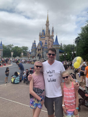 Dan Geffers poses for a photo with daughters Lila (Left, aged 13) and Bryn (age 11, on the right) in front of Cinderella