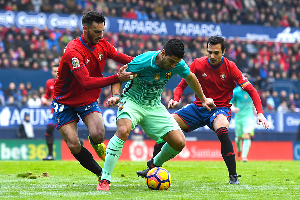 PAMPLONA, SPAIN - DECEMBER 10: Luis Suarez of FC Barcelona competes for the ball with Ivan Marquez (L) and Miguel Flanonof CA Osasuna during the La Liga match between CA Osasuna and FC Barcelona at Sadar stadium on December 10, 2016 in Pamplona, Spain. (Photo by David Ramos/Getty Images)