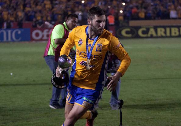 Tigres' Andre Pierre Gignac celebrates with the trophy after defeating America during their Mexican Apertura 2016 tournament football final match at the Universitario stadium in Monterrey, Mexico. On December 25, 2016. / AFP / Julio Cesar AGUILAR (Photo credit should read JULIO CESAR AGUILAR/AFP/Getty Images)