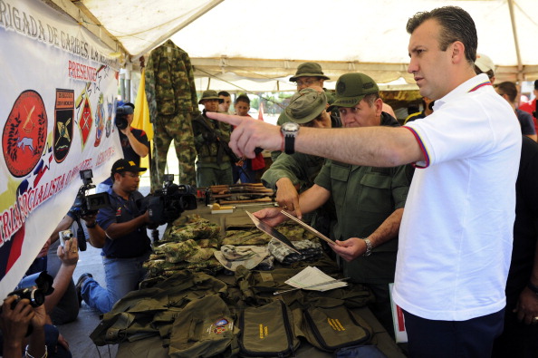 Tareck El Aissami (Der.) mostrando ropa, bolsas y otras cosas que se encuentran en un laboratorio de drogas desmantelada por la Guardia Nacional de la frontera, en Táchira, Venezuela, el 10 de agosto de 2011. (LEO RAMIREZ / AFP / Getty Images)